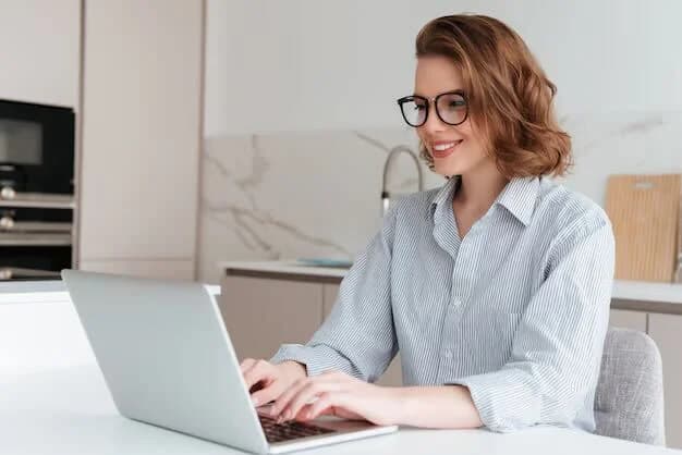 American professional working on a laptop at home in the United Kingdom
