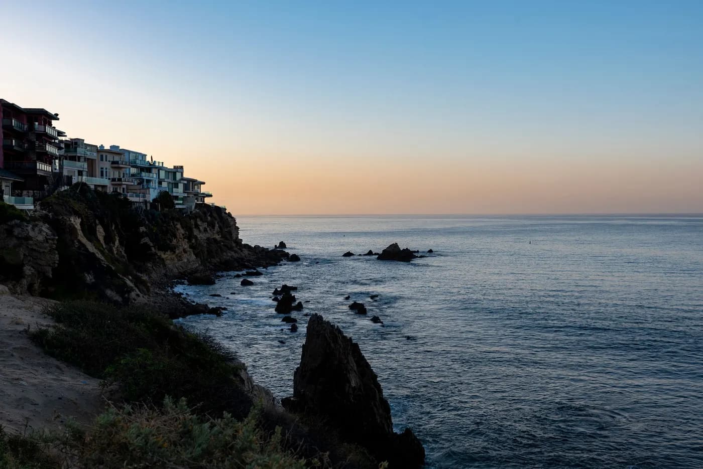 Orange County coastline with cliffside homes at sunset