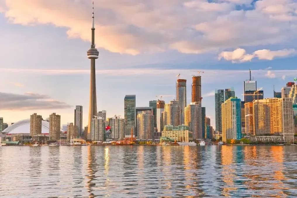 Toronto skyline with the CN Tower across Lake Ontario at sunset